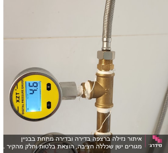 מד לחץ דיגיטלי ומד אנלוגי מחוברים לצינור מתכת